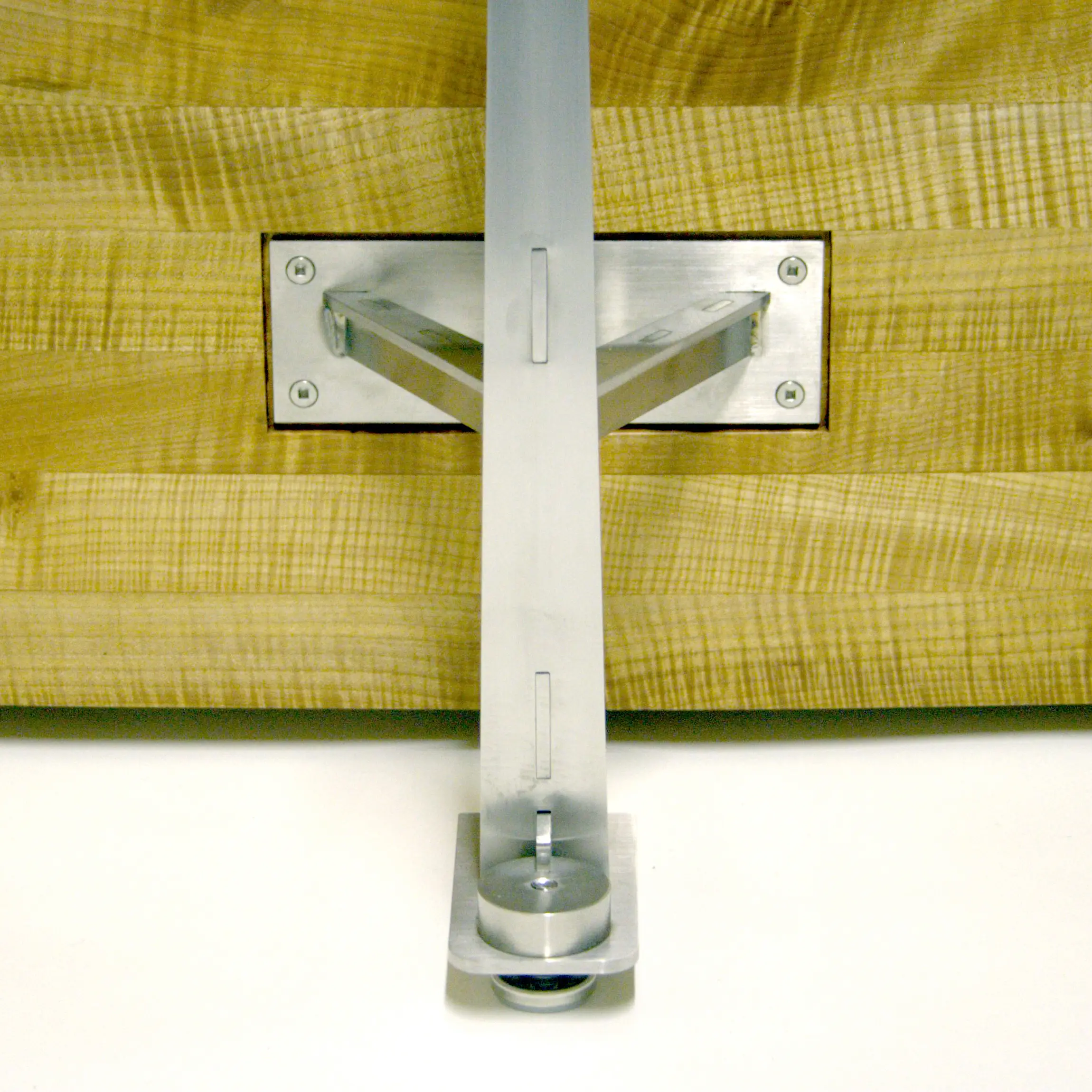 Close-up of stainless steel support bracket attached to the Erosion Table wooden centerpiece