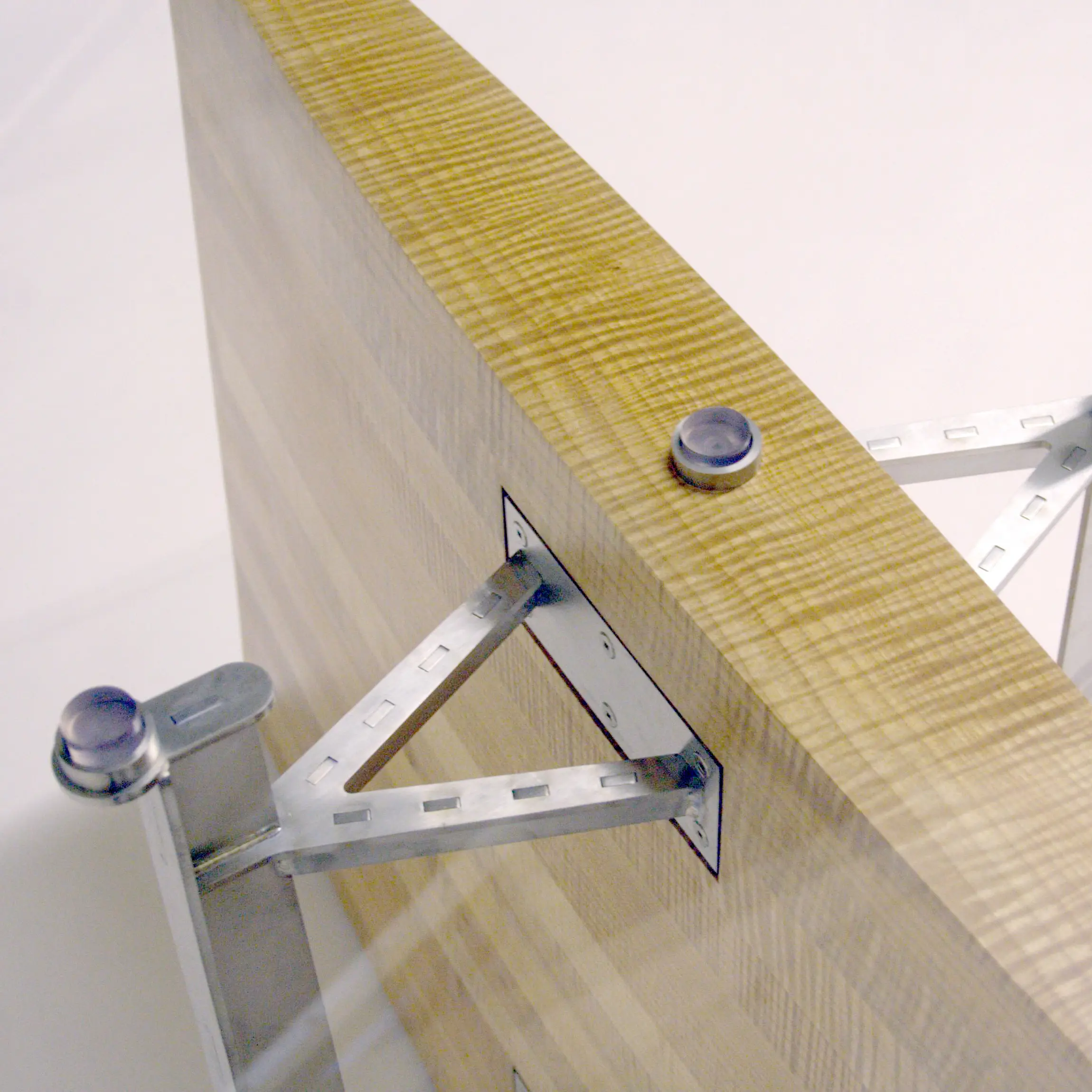 Angled view of the Erosion Table wooden centerpiece and precision-engineered steel connections