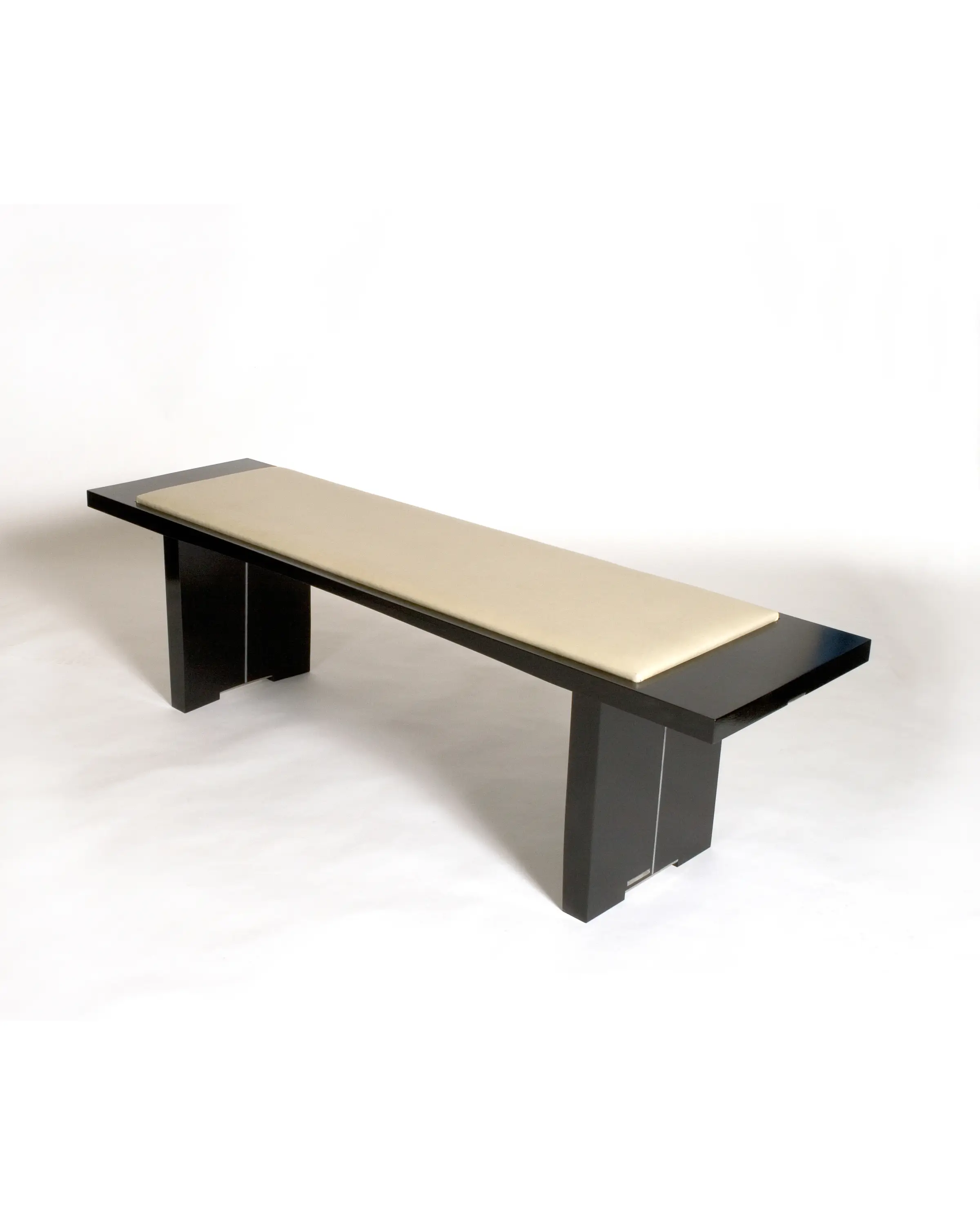 Hisashiburi Bench featuring an elongated wooden frame and elevated upholstered seating platform