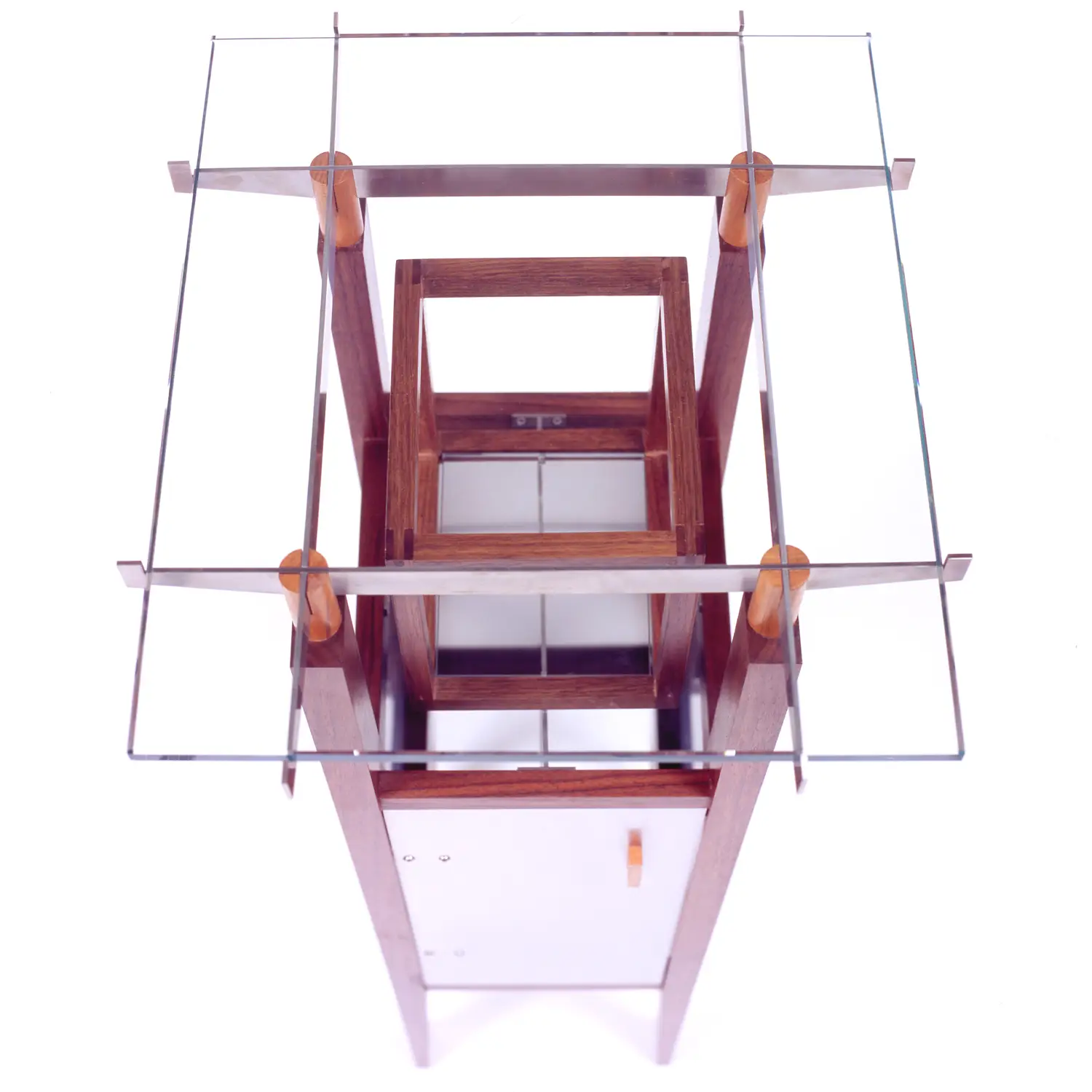 Elevated view of the Isan Table revealing its glass surface and geometric wooden framework