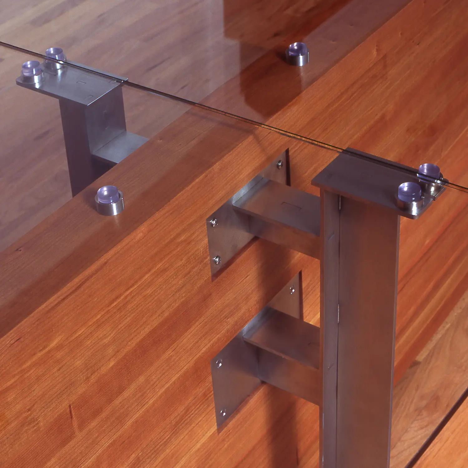 Jaffe Table architectural furniture design featuring a glass surface above its sculptural base