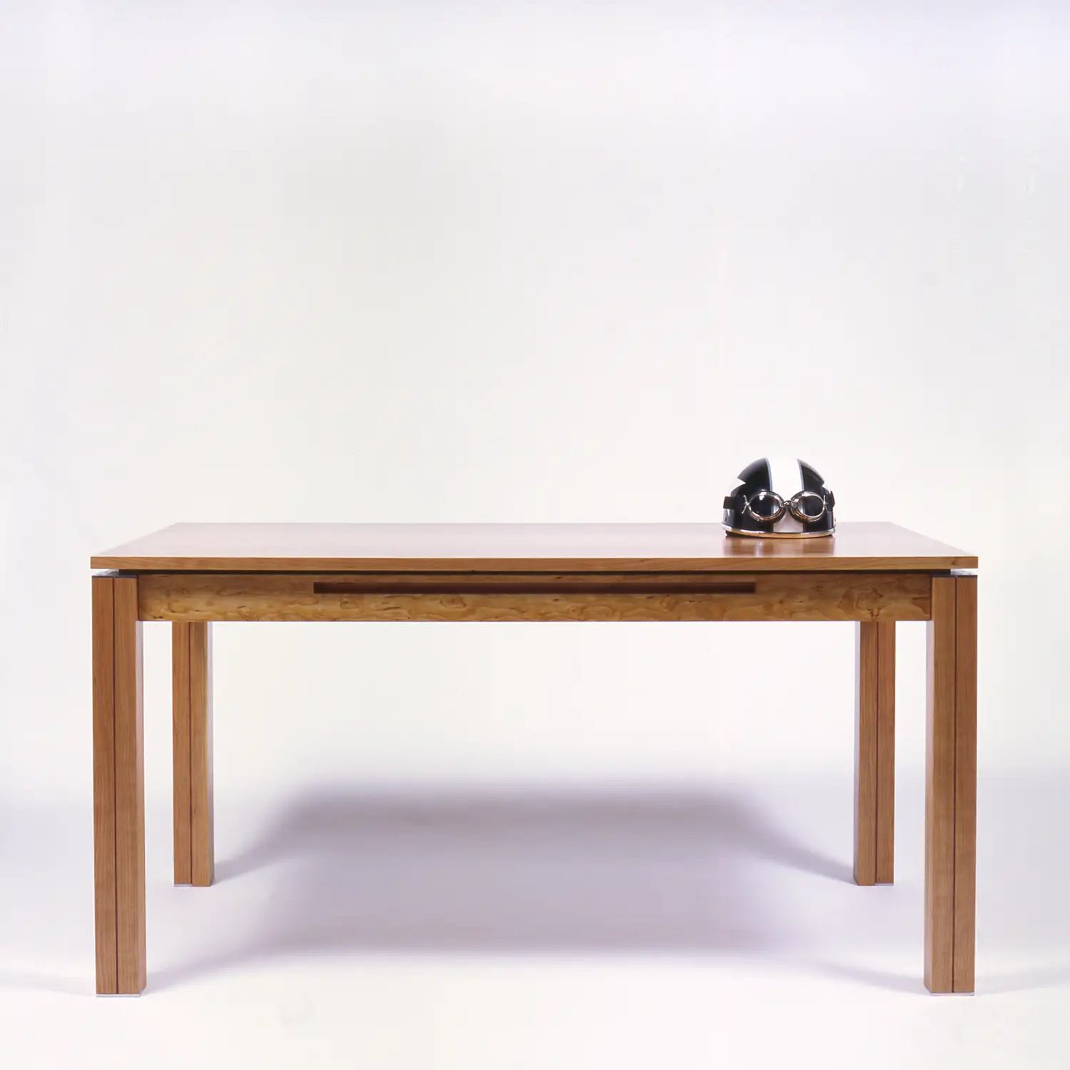 Simple Desk One wooden desk with four straight legs and a concealed drawer beneath the top