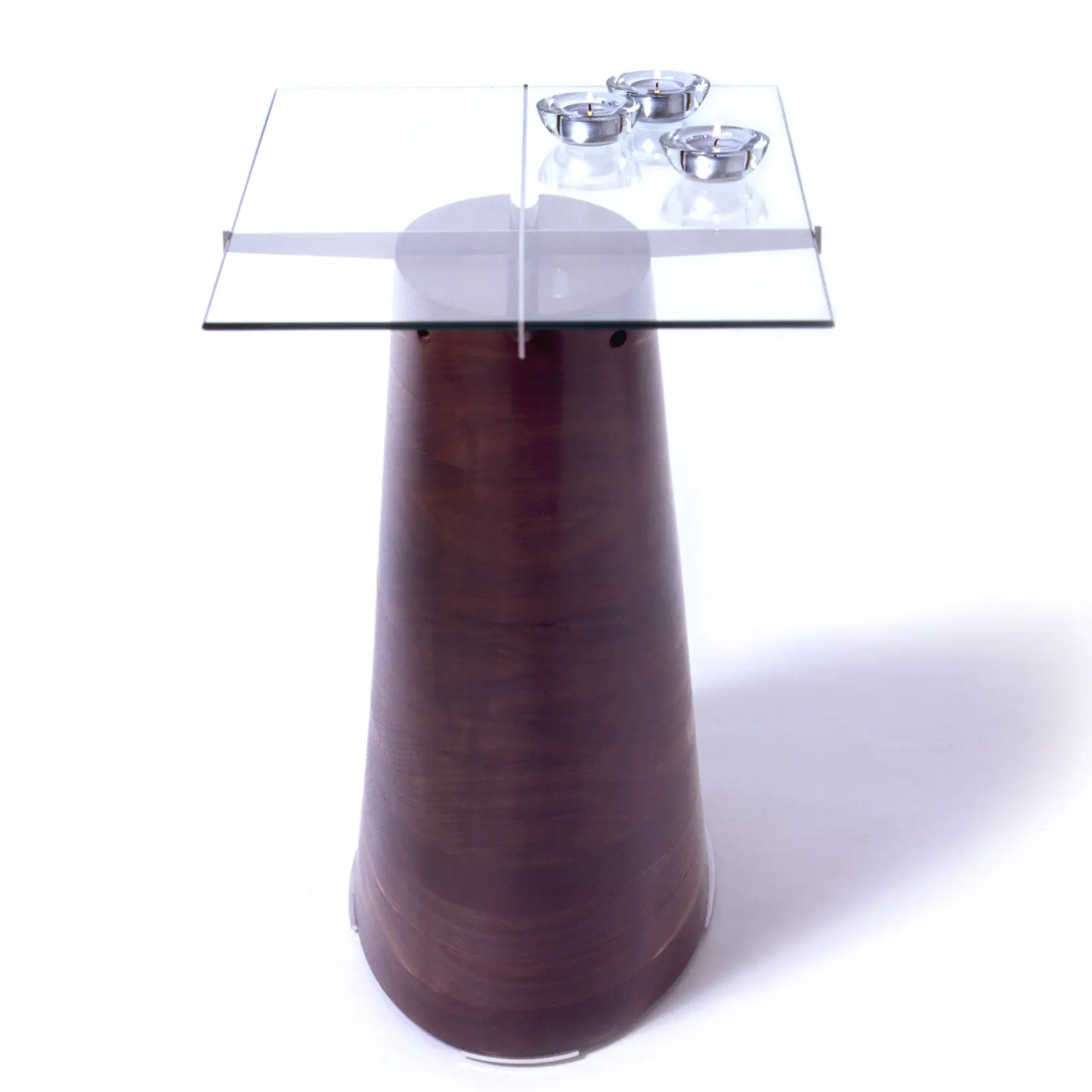 Trunk Table with a tapered walnut base supporting a transparent glass tabletop.