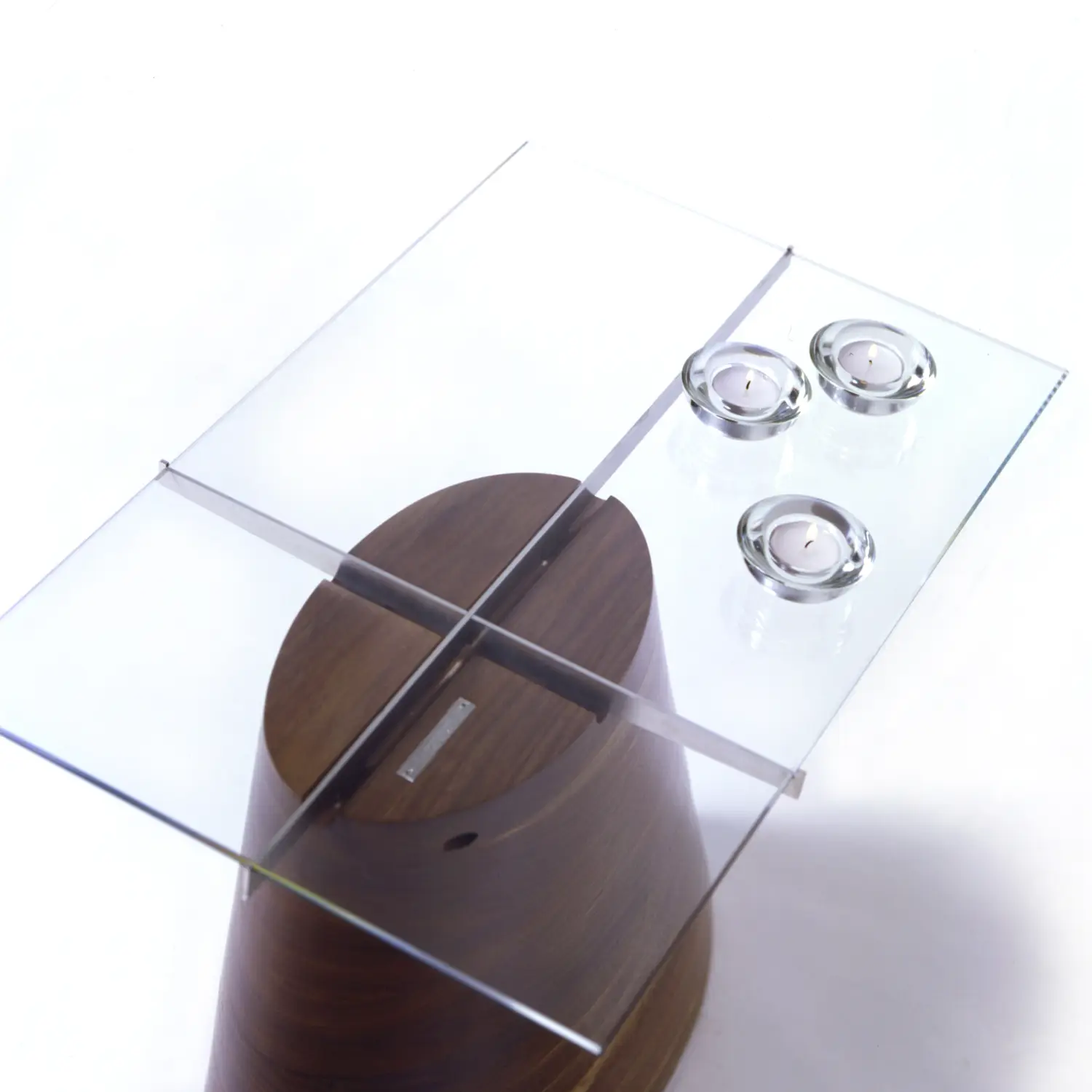 Overhead detail of the Trunk Table revealing the intersecting supports beneath the glass tabletop.